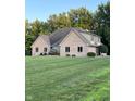 Attractive brick home showcasing lush green landscaping and well-maintained lawn on a sunny day at 5993 E County Road 100 S, Avon, IN 46123