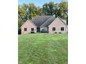 Charming brick home with a lush lawn, and a well-manicured yard, offering great curb appeal at 5993 E County Road 100 S, Avon, IN 46123