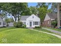 Classic single-Gathering home with manicured lawn, detached garage, and mature trees at 6009 Ralston Ave, Indianapolis, IN 46220