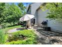 Serene backyard showcasing a patio with outdoor dining set and a decorative water feature at 6298 Briargate Dr, Zionsville, IN 46077