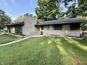 Attractive single-story home featuring a brick facade, chimney, and well-maintained lawn at 6430 N Rural St, Indianapolis, IN 46220