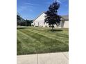 Exterior view of home showcasing the pristine lawn and lovely landscaping at 712 Disciples Way, Greenwood, IN 46143