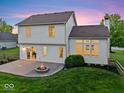 Private backyard featuring a brick patio and fire pit, perfect for entertaining and relaxing with Gathering at 8835 Harrison Pkwy, Fishers, IN 46038