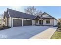 Lovely home exterior featuring an attached garage, spacious driveway, and manicured landscaping at 886 J Mccool Way, Greenwood, IN 46142