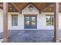 Inviting front porch with stone flooring, wooden posts, and double front doors at 886 J Mccool Way, Greenwood, IN 46142