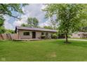 Charming single-story home with well-manicured lawn and mature shade trees at 11230 N College Ave, Carmel, IN 46032