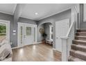 Elegant foyer with hardwood floors, decorative lighting, and staircase at 1141 W 35Th St, Indianapolis, IN 46208