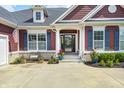 Cozy front porch with decorative plants, a bench, and an inviting entryway enhance this home's charm at 11626 Laurel Springs Cir, Noblesville, IN 46060