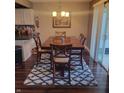 Well-lit dining area featuring a dining table on an area rug and sliding glass door at 11985 Cat Tail Ct, Noblesville, IN 46060