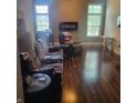 Spacious living room with hardwood floors, modern fireplace, and large windows at 11985 Cat Tail Ct, Noblesville, IN 46060