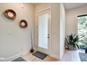 Modern foyer featuring a frosted glass door, sleek light fixtures, and a beautiful plant accent at 1311 Central Ave, Indianapolis, IN 46202