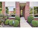 Front entrance showcases neat landscaping and glass-paneled front door, creating inviting curb appeal at 1311 Central Ave, Indianapolis, IN 46202