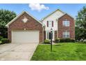 Charming two-story home features a brick facade, attached garage, and well-maintained lawn at 13264 Penneagle Dr, Carmel, IN 46033