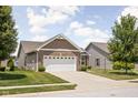Well-kept lawn and landscaping add to this home's inviting exterior at 1418 Blackthorne S Trl, Plainfield, IN 46168
