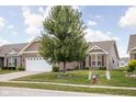 Beautifully landscaped front yard with a mature tree enhancing curb appeal at 1418 Blackthorne S Trl, Plainfield, IN 46168