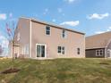 Expansive backyard featuring a well-kept lawn and views of the home's back exterior at 164 Luna Pl, Shelbyville, IN 46176