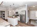 Bright kitchen with stainless steel appliances, center island, and wood flooring at 164 Luna Pl, Shelbyville, IN 46176