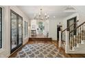 Elegant foyer with hardwood floors, staircase, and an open view to the living room at 1805 Wood Valley Dr, Carmel, IN 46032