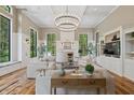 Bright and airy living room with large windows, fireplace, and stylish furnishings at 1805 Wood Valley Dr, Carmel, IN 46032