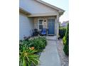 Inviting front porch with seating and lovely landscaping, perfect for relaxing outdoors at 1823 Long Lake Dr, Greenwood, IN 46143