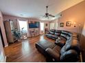 Bright living room with wood floors, a large sectional, and an entertainment center at 1823 Long Lake Dr, Greenwood, IN 46143