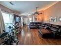 Spacious living room with vaulted ceilings, wood floors, and a comfortable leather sectional at 1823 Long Lake Dr, Greenwood, IN 46143