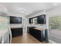 This kitchen features stainless steel appliances, dark cabinets, butcher block counters, and a sliding door to the patio at 1930 Bechtel Rd, Indianapolis, IN 46260