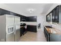 Updated kitchen features stainless steel appliances, dark cabinets, butcher block countertops, and subway tile backsplash at 1930 Bechtel Rd, Indianapolis, IN 46260