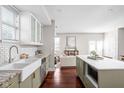 Modern kitchen with white cabinets, farmhouse sink, island, and stainless steel appliances at 2015 N College Ave, Indianapolis, IN 46202