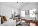 Bright main bedroom with vaulted ceiling, hardwood floors, and natural light from large windows at 2015 N College Ave, Indianapolis, IN 46202