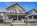 Inviting two-story duplex showcasing a charming front porch, creating an inviting and comfortable atmosphere at 2332 Central Ave, Indianapolis, IN 46205