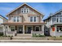Inviting two-story duplex showcasing a charming front porch, offering a warm and welcoming curb appeal at 2332 Central Ave, Indianapolis, IN 46205
