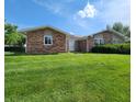Well-kept brick house with a neat lawn, inviting entrance, and classic architectural style at 3415 Winchester Dr, Indianapolis, IN 46227