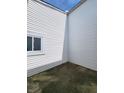 Enclosed patio area with vinyl siding and concrete flooring, providing a private outdoor space at 3415 Winchester Dr, Indianapolis, IN 46227