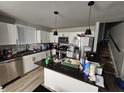 Modern kitchen with white cabinets, stainless steel appliances, and granite countertops at 3836 N Wittfield St, Indianapolis, IN 46235