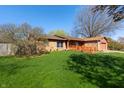 Well maintained single-story home with a well-kept lawn and mature trees in a peaceful residential neighborhood at 40 S Restin Rd, Greenwood, IN 46142