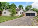 Home with a two-car garage and wide driveway at 402 W Clinton St, Danville, IN 46122