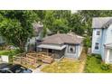 Aerial front view of the home featuring a wooden ramp and lattice-covered porch at 405 Harlan St, Indianapolis, IN 46201