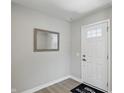 Bright foyer featuring a stylish mirror, a white front door, and a neutral color palette at 4182 Hume Ave, Plainfield, IN 46168