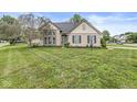 Well-maintained home featuring a lush green lawn and beautiful landscaping surrounding the property at 5299 Breakers Way, Carmel, IN 46033