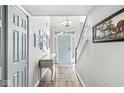 Bright foyer boasts tile flooring, staircase, and a stylish console table with a pale blue entry door at 5299 Breakers Way, Carmel, IN 46033