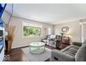 Comfortable living room with plush seating, natural light, and a stylish round coffee table at 5672 W New York St, Indianapolis, IN 46224