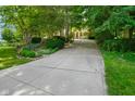 Long driveway leading to a lush, wooded lot, creating a private and serene entrance to the property at 5720 Hickory Hollow Dr, Plainfield, IN 46168