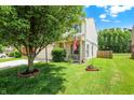Home's exterior with a lush lawn, charming landscaping, and a welcoming entrance at 5841 Sable Dr, Indianapolis, IN 46221