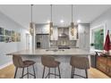 Bright modern kitchen featuring quartz counters, stainless steel appliances, and a stylish island at 5903 Birchwood Ave, Indianapolis, IN 46220