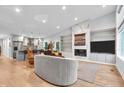 Open concept living room featuring modern fireplace, hardwood floors, and gourmet kitchen at 5903 Birchwood Ave, Indianapolis, IN 46220