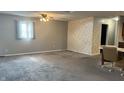 Large living room features neutral carpet, ceiling fan, and ample space for furniture at 6408 W Taylor Rd, Muncie, IN 47304