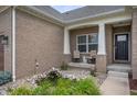 Inviting front porch with seating area and decorative pond surrounded by lush landscaping at 6420 Colt Ln, Anderson, IN 46013