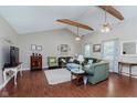 Cozy living room featuring hardwood floors, exposed ceiling beams, and comfortable seating at 6550 Reed Rd, Pittsboro, IN 46167