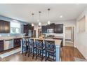 Beautiful kitchen with a center island, dark wood cabinets, granite countertops, and stainless steel appliances at 6589 Kara Ln, Brownsburg, IN 46112